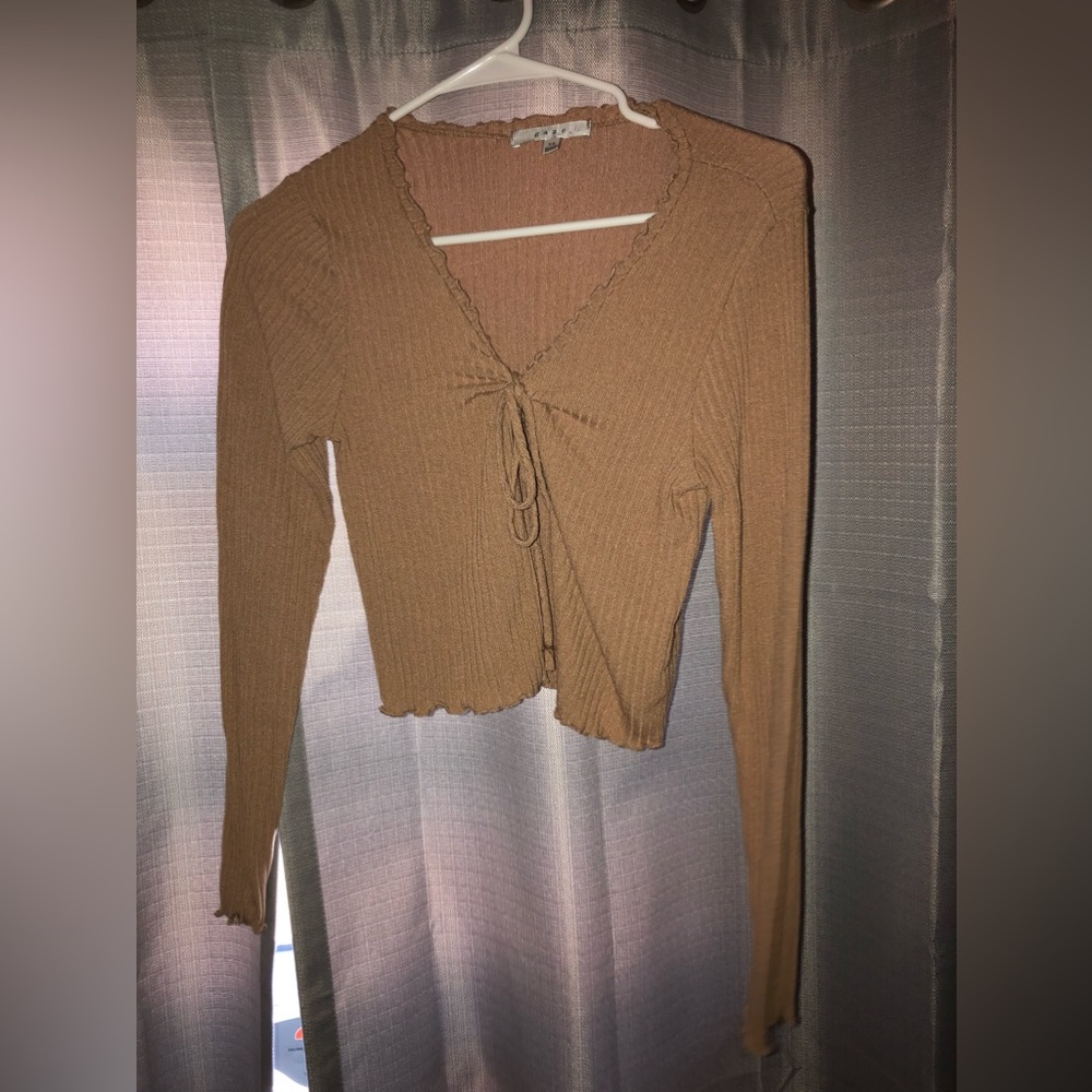 Light brown cropped cardigan that ties in front.